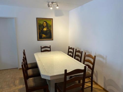 a dining room with a white table and chairs at St. Moritz in St. Moritz
