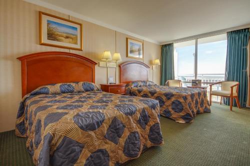 a hotel room with two beds and a balcony at Sahara Motel in Ocean City