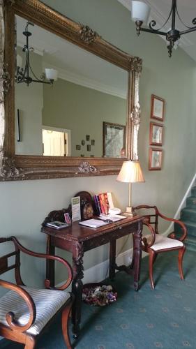 a woman laying on a desk in a room with a mirror at 17 Wilmington Square in Eastbourne