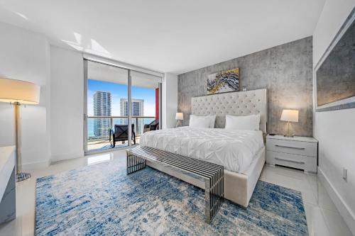 a bedroom with a large bed and a large window at BeachWalk Resort #2902 - WATERFRONT RESORT HOME with DIRECT OCEAN VIEW in Hallandale Beach