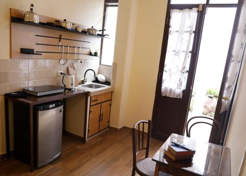 a small kitchen with a sink and a table at Olala house in Sucre