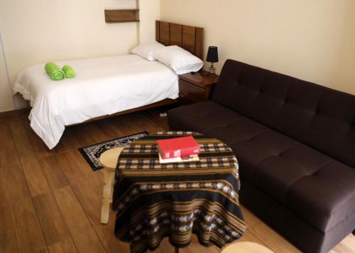 a living room with a couch and a bed at Olala house in Sucre