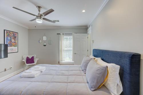 a bedroom with a large bed with a ceiling fan at Hip and Spacious Midtown Cottage near Beale Street in Memphis