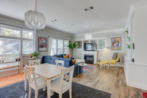 a living room with a blue couch and a table at Hip and Spacious Midtown Cottage near Beale Street in Memphis