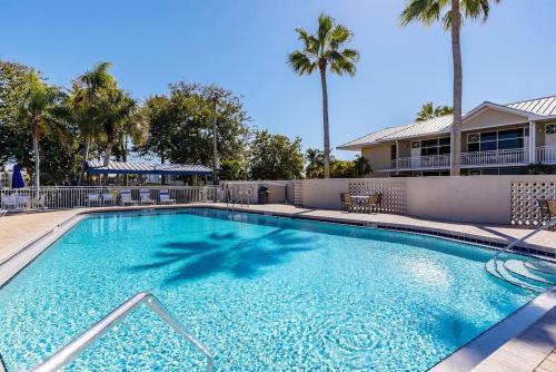 a large blue swimming pool with palm trees at Your stay on the Bay! in Ruskin