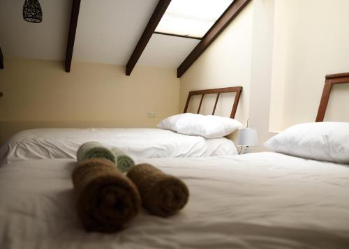 a person laying on a bed between two beds at Olala house in Sucre