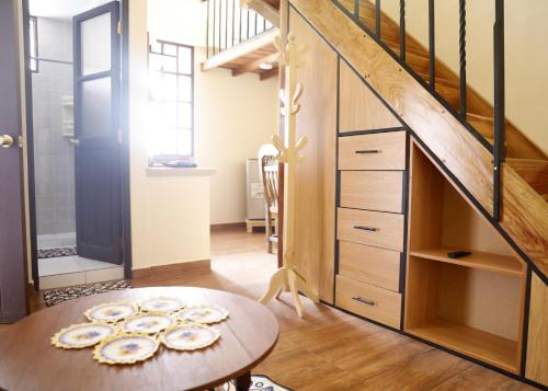 a room with a table and a staircase at Olala house in Sucre