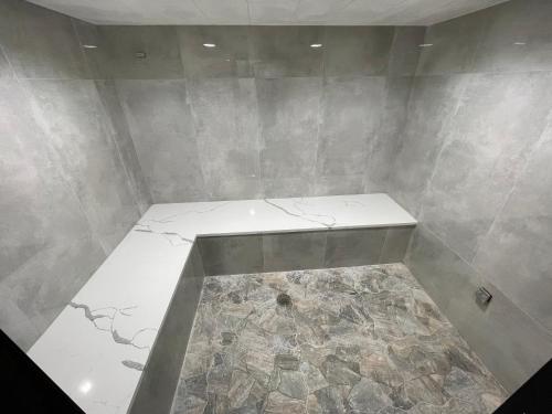 a room with a counter with a stone floor at Pine Lake Resort and Banquets in LaPorte