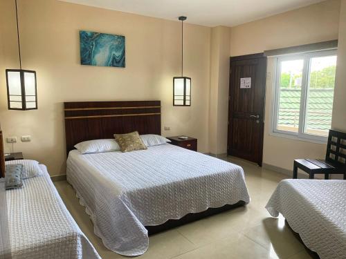 a bedroom with a large bed and a window at Hotel Boutique Nazo in Manta