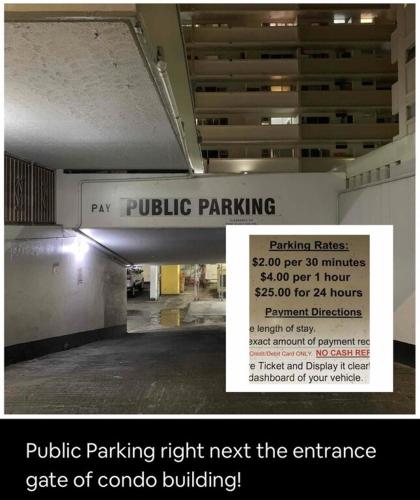 a sign for a parking garage with a price of concrete building at Lovely Condo 2 Bedrooms, 2 bathrooms, free 1 Parking at Waikiki Beach in Honolulu