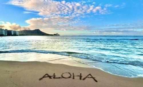 a beach with the word aloha written in the sand at Lovely Condo 2 Bedrooms, 2 bathrooms, free 1 Parking at Waikiki Beach in Honolulu
