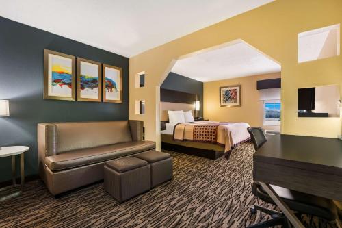 a hotel room with a bed and a desk at Best Western Bradbury Inn & Suites in Perry