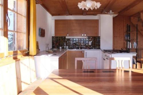 a large kitchen with white appliances and wooden cabinets at Gfell in Matt