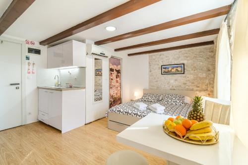 a kitchen and a living room with a bed and a table at Sv.Duje Apartments in Split