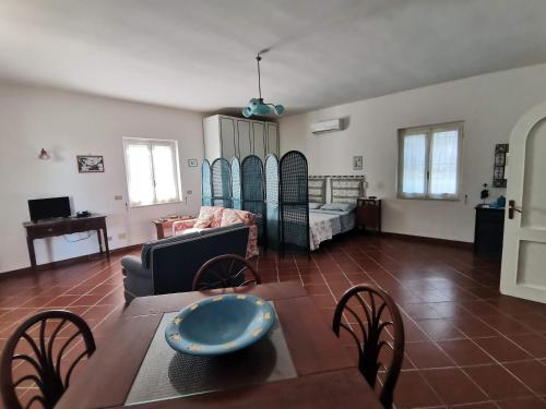 ein Wohnzimmer mit einem Tisch, Stühlen und einem Sofa in der Unterkunft Tenuta Solleone in Peschici