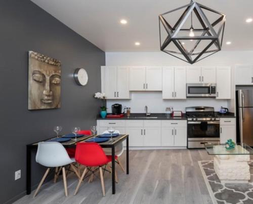 a kitchen with a dining table and red chairs at Cheerful Affordable Private Rooms Shared Bath near SFO - UP in South San Francisco