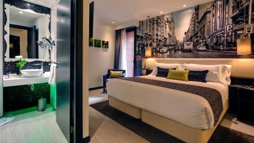 a hotel room with a bed and a bathroom at Hotel Indigo Madrid - Gran Vía by IHG in Madrid