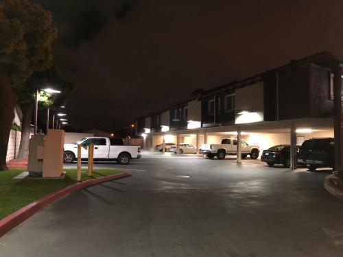 a parking lot with cars parked in front of a building at Casa Royal Inn in San Jose