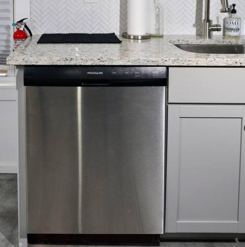 a stainless steel dishwasher in a kitchen with a counter at Boston Historical Urban Oasis in Boston