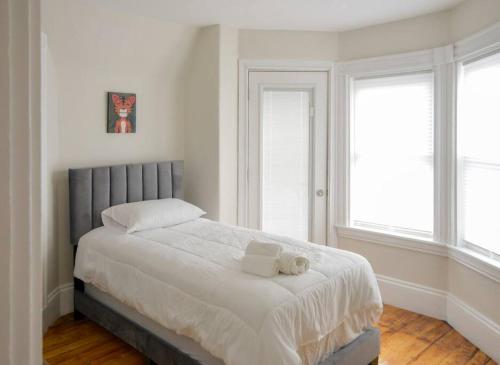 a bedroom with a bed with two towels on it at Boston Historical Urban Oasis in Boston