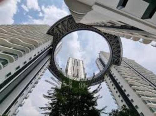 a mirror on the side of a building with a tree at Studio near KLCC and LRT with superb view in Kuala Lumpur