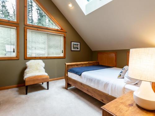 a bedroom with a bed and two windows at Naturbyn Cabin in Glacier