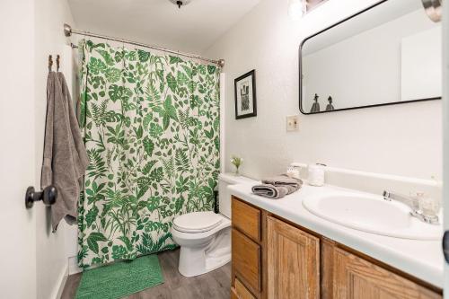 a bathroom with a sink and a shower curtain at THE SHORELINE- Beach Access, Ocean Views, Private in Kodiak
