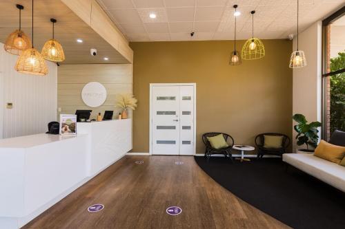 an office with a reception counter and chairs and a couch at Contour Hotel Katherine in Katherine