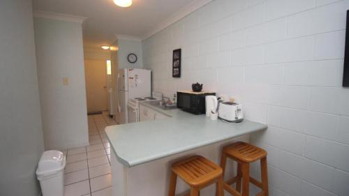 a kitchen with a counter and two stools at Unit 3 Beachcomber, Arcadia in Arcadia