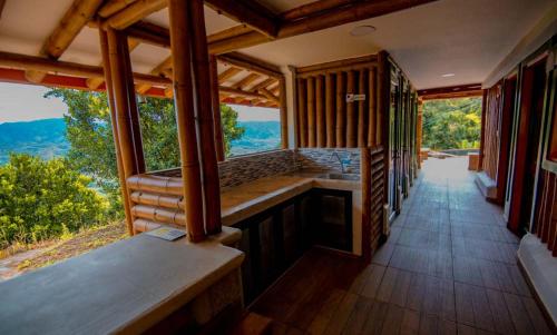 a house with a porch with a view of the mountains at Hotel Terra Belén in Belén de Umbría