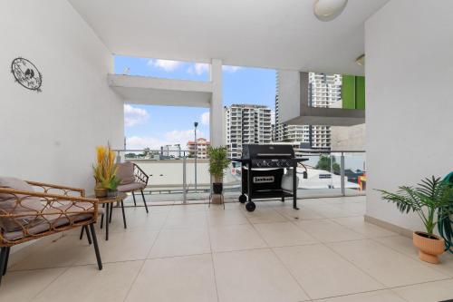 an open living room with a balcony with a grill at Darwin Lux Living in Darwin