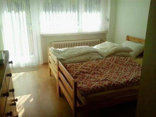 - une chambre avec deux lits en face d'une fenêtre dans l'établissement Haus Rhoneblick, à Loèche-les-Bains