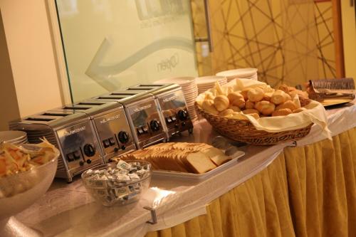 a buffet with bread and other foods on a table at Hotel Rivus in Peschiera del Garda