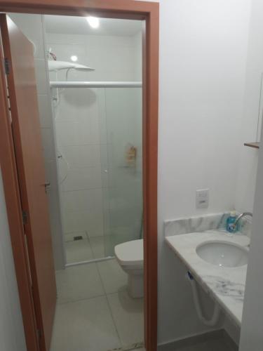 ein Badezimmer mit Dusche, Toilette und Waschbecken in der Unterkunft Condomínio da fé Canção Nova Com Garagem in Cachoeira Paulista