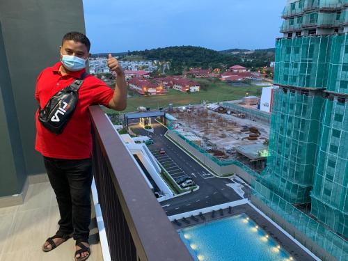 a man in a mask standing on the ledge of a building at Desaru Utama Apartment with Swimming Pool View, Karaoke, FREE WIFI, Netflix, near to Car Park in Desaru