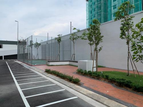 an empty parking lot in front of a building at Desaru Utama Apartment with Swimming Pool View, Karaoke, FREE WIFI, Netflix, near to Car Park in Desaru