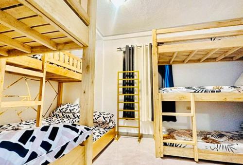 a room with two bunk beds and a room with at RedDoorz Plus @ Remarkable Hotel Alcala Pangasinan 