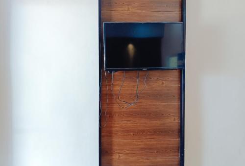 a tv on a wooden door with a television on it at Hakysia Hotel 