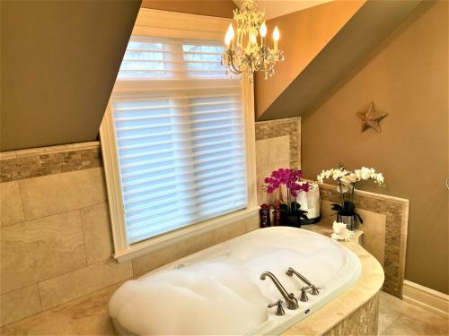a bathroom with a large tub and a window at iResidence in Toronto - Unique Mansion - Fantastic Views with Breakfast in Toronto