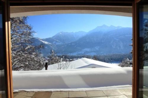a bath tub with a view of the mountains at Chalet Mon Refuge in Laax