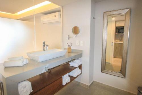 a bathroom with a sink and a mirror at Beachfront & free daily breakfast & 600MB 7010 Wifi by Moikkarentals in Puerto Vallarta