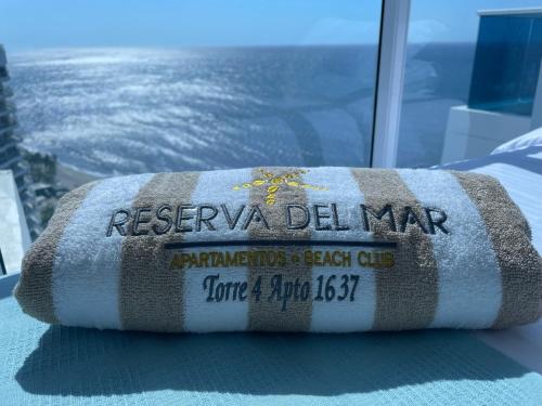 a rolled up towel sitting on a table in front of a window at APARTAMENTO CON VISTA AL MAR, RESERVA Del MAR 1637 in Gaira