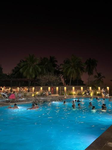 a group of people in a swimming pool at night at APARTAMENTO CON VISTA AL MAR, RESERVA Del MAR 1637 in Gaira