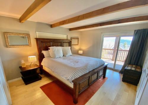a bedroom with a bed and a large window at Modern 6 bedroom retreat, stunning lake views, close to village! in Lake Arrowhead