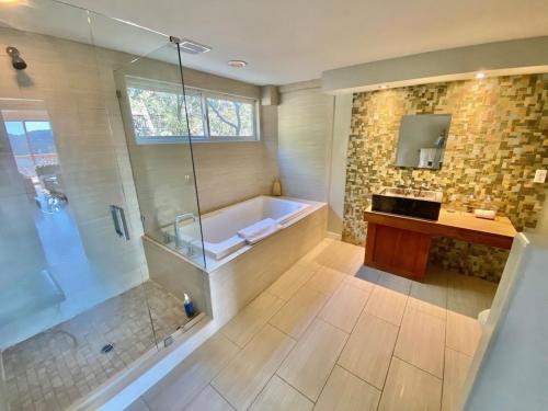 a large bathroom with a tub and a shower at Modern 6 bedroom retreat, stunning lake views, close to village! in Lake Arrowhead