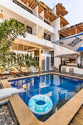 a swimming pool in a villa with a resort at Punta Kai Hotel & Hostal in Puerto Escondido