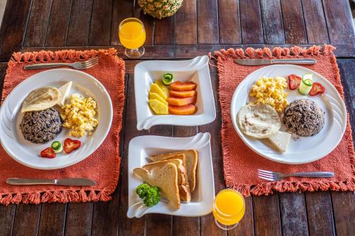 two plates of breakfast food on a table at Hotel Hacienda del Mar in Carrillo