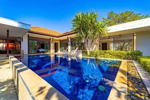 a swimming pool in front of a house at 3 Bedroom Pool Villa in Great Location! BUB in Hua Hin