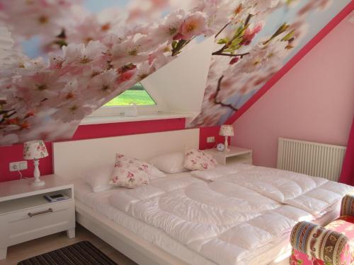 a bedroom with a bed with a flower painting on the ceiling at Haus Dornröschen in Rakow