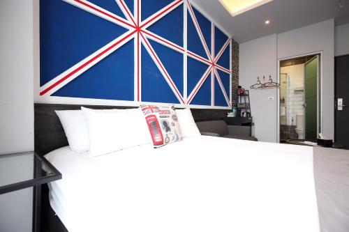 a bedroom with a bed with a large painting on the wall at 海享電梯民宿-近夜市-近海邊 in Hualien City
